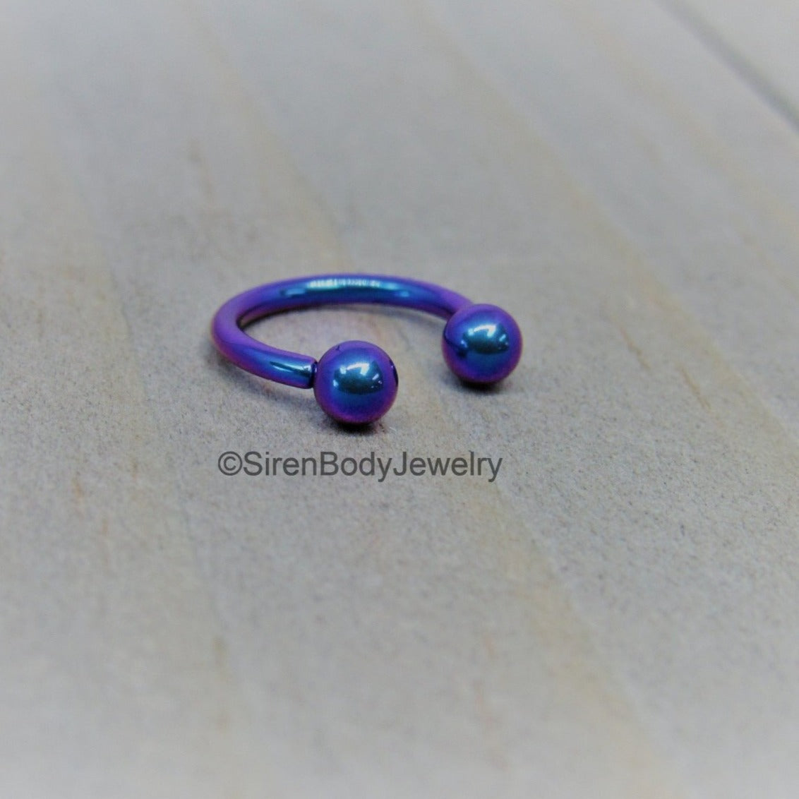 http://sirenbodyjewelry.com/cdn/shop/products/titanium-16g-circular-barbell-blurple-septum-horseshoe-internally-threaded-daith-ring-516-241767.jpg?v=1636057016