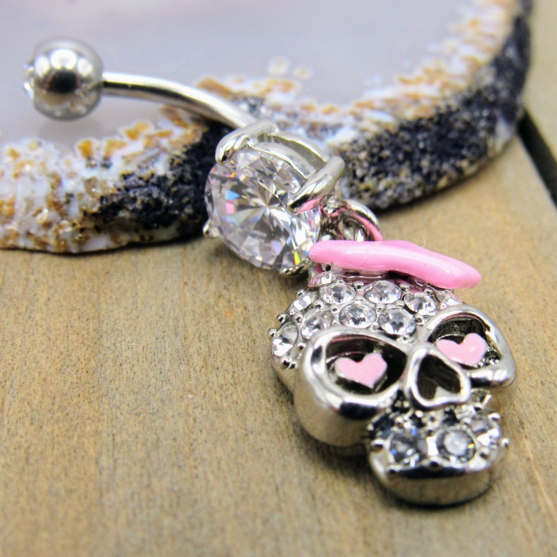 14g Skull belly button piercing ring 7/16" crystal clear gemstones pink bow heart dangle design - Siren Body Jewelry