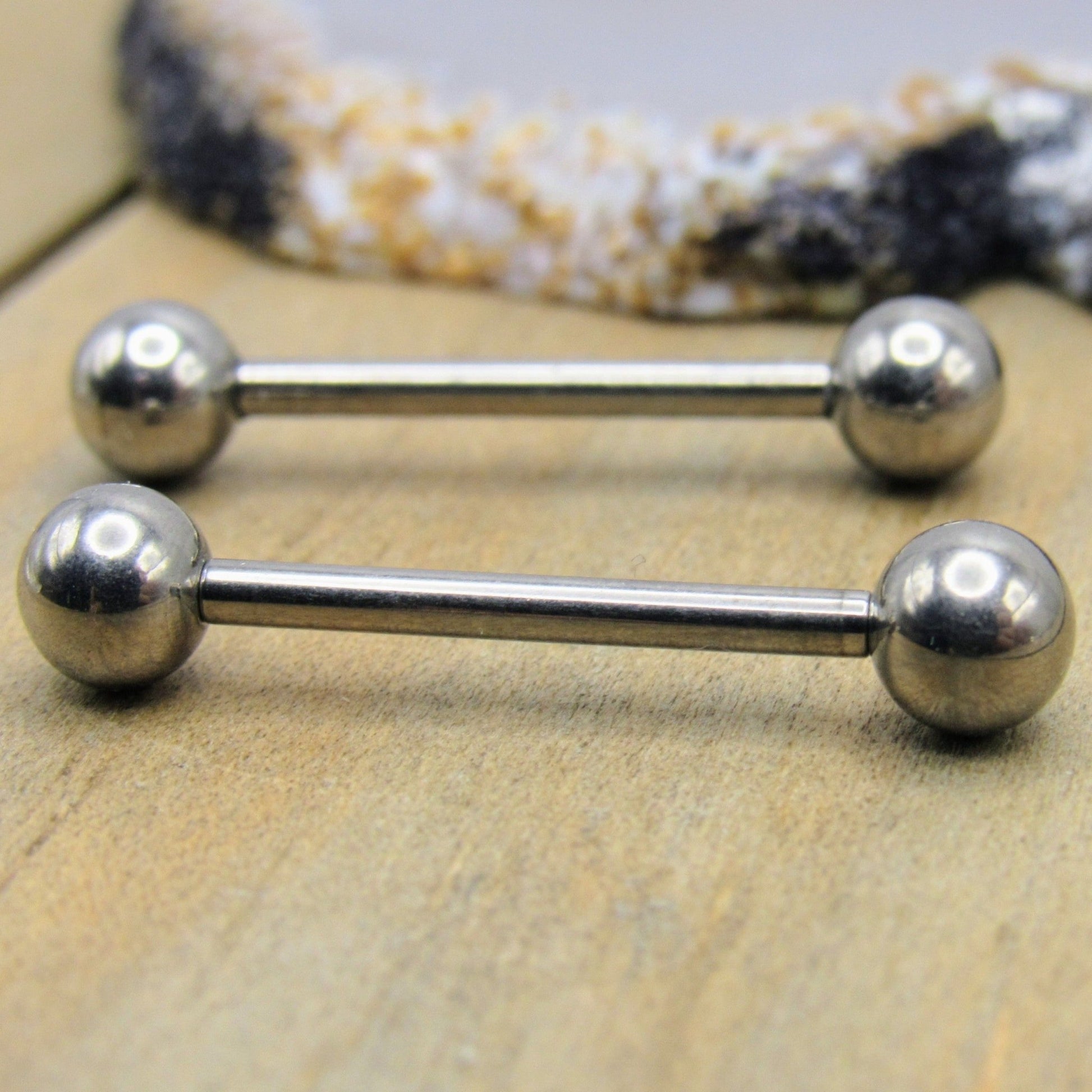 https://sirenbodyjewelry.com/cdn/shop/products/14g-titanium-nipple-piercing-barbell-set-straight-high-polish-silver-internally-threaded-body-jewelry-pair-982865.jpg?v=1672816382&width=1946