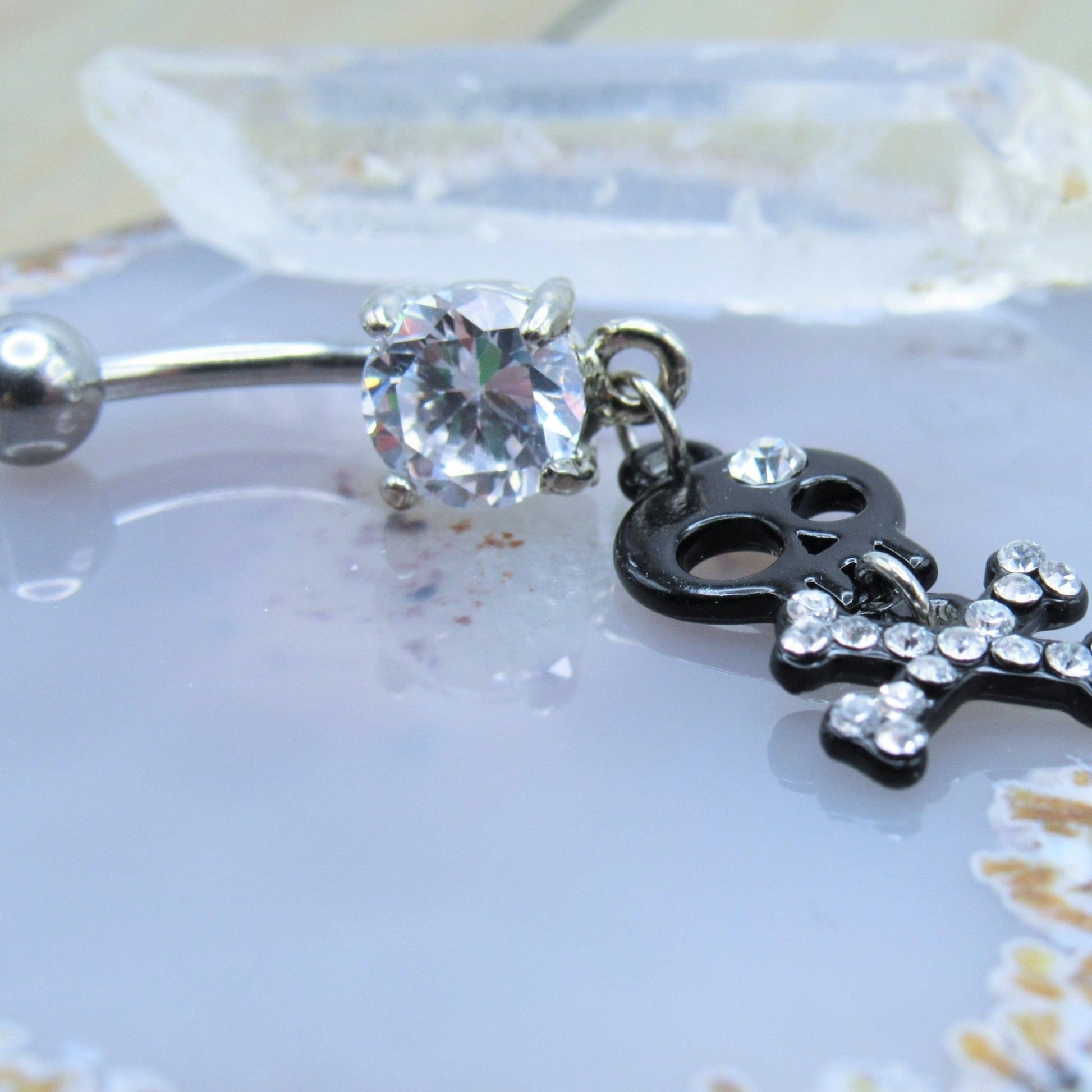 Black skull dangle belly button piercing ring 14g cz gemstones prong set studded crossbone navel bar - Siren Body Jewelry