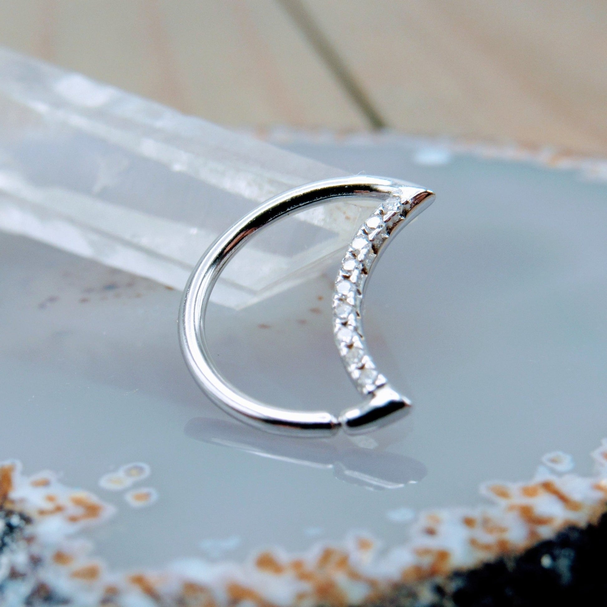 https://sirenbodyjewelry.com/cdn/shop/products/crescent-moon-crystal-gemstone-silver-easy-bend-seam-ring-daith-rook-helix-piercing-hoop-925-sterling-silver-177418.jpg?v=1681144592&width=1946