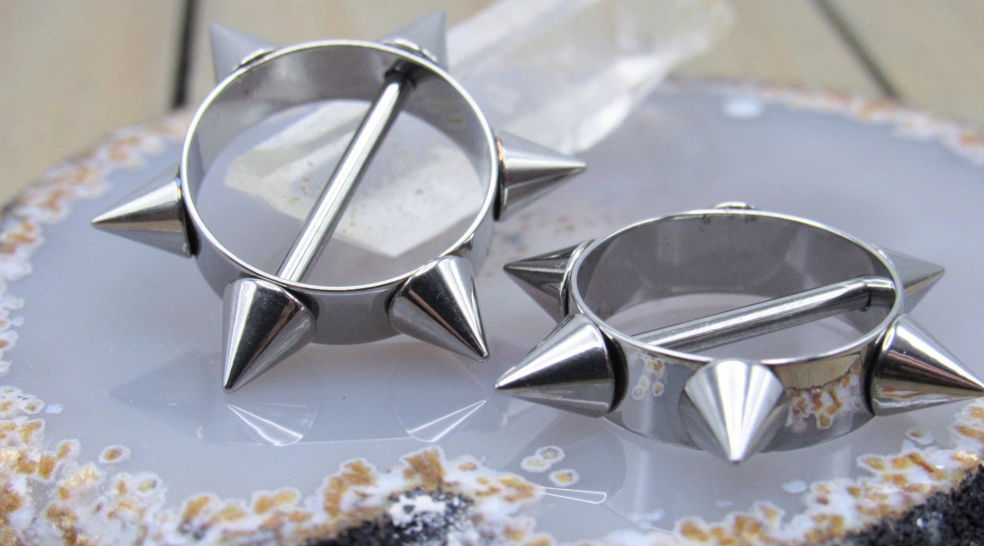 https://sirenbodyjewelry.com/cdn/shop/products/silver-spikes-nipple-piercing-shield-set-14g-silver-316l-stainless-steel-straight-externally-threaded-bars-458625.jpg?v=1677703234&width=1946