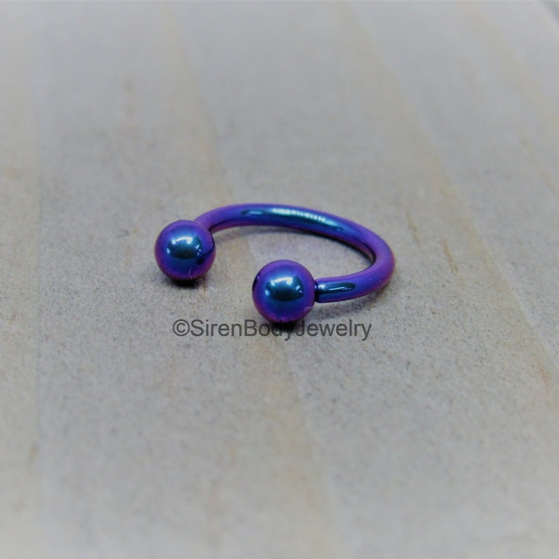 https://sirenbodyjewelry.com/cdn/shop/products/titanium-16g-circular-barbell-blurple-septum-horseshoe-internally-threaded-daith-ring-516-943718.jpg?v=1636057057&width=1445
